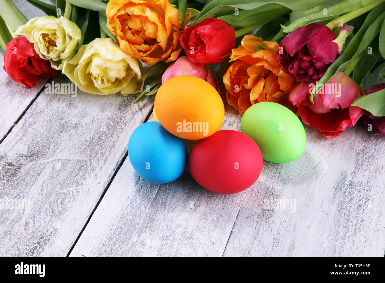 Festive table setting for Easter with colorful eggs and tulip on spring Stock Photo