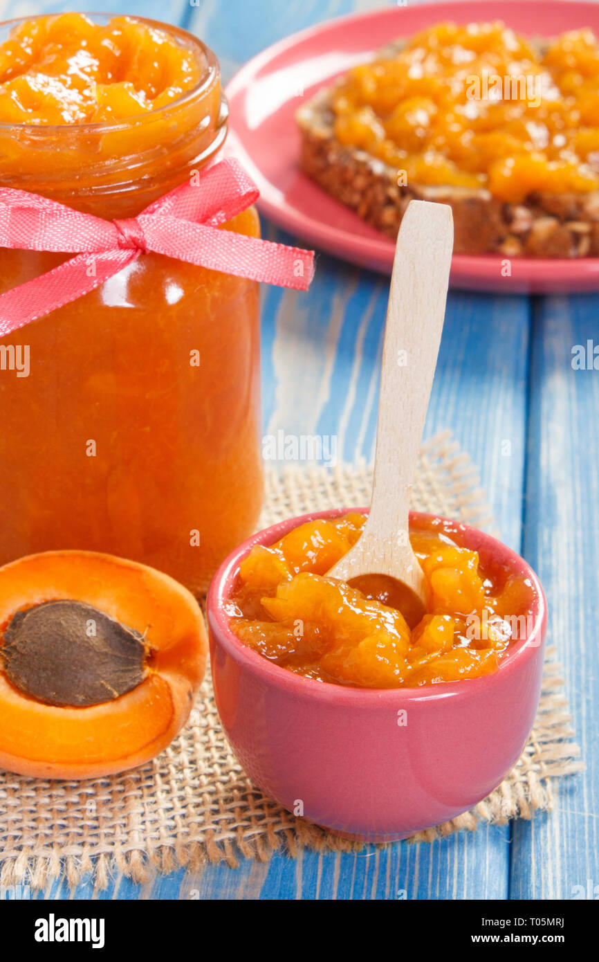 Fresh homemade apricot marmalade, ripe fruits and fresh prepared sandwich, concept of healthy sweet dessert Stock Photo