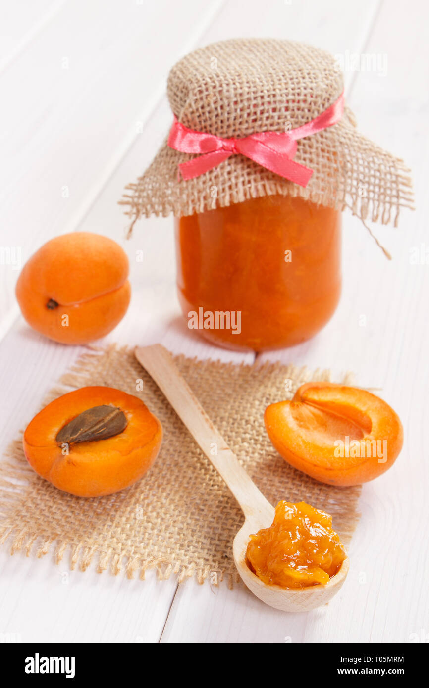 Fresh prepared homemade apricot marmalade and ripe fruits, concept of healthy sweet eating Stock Photo