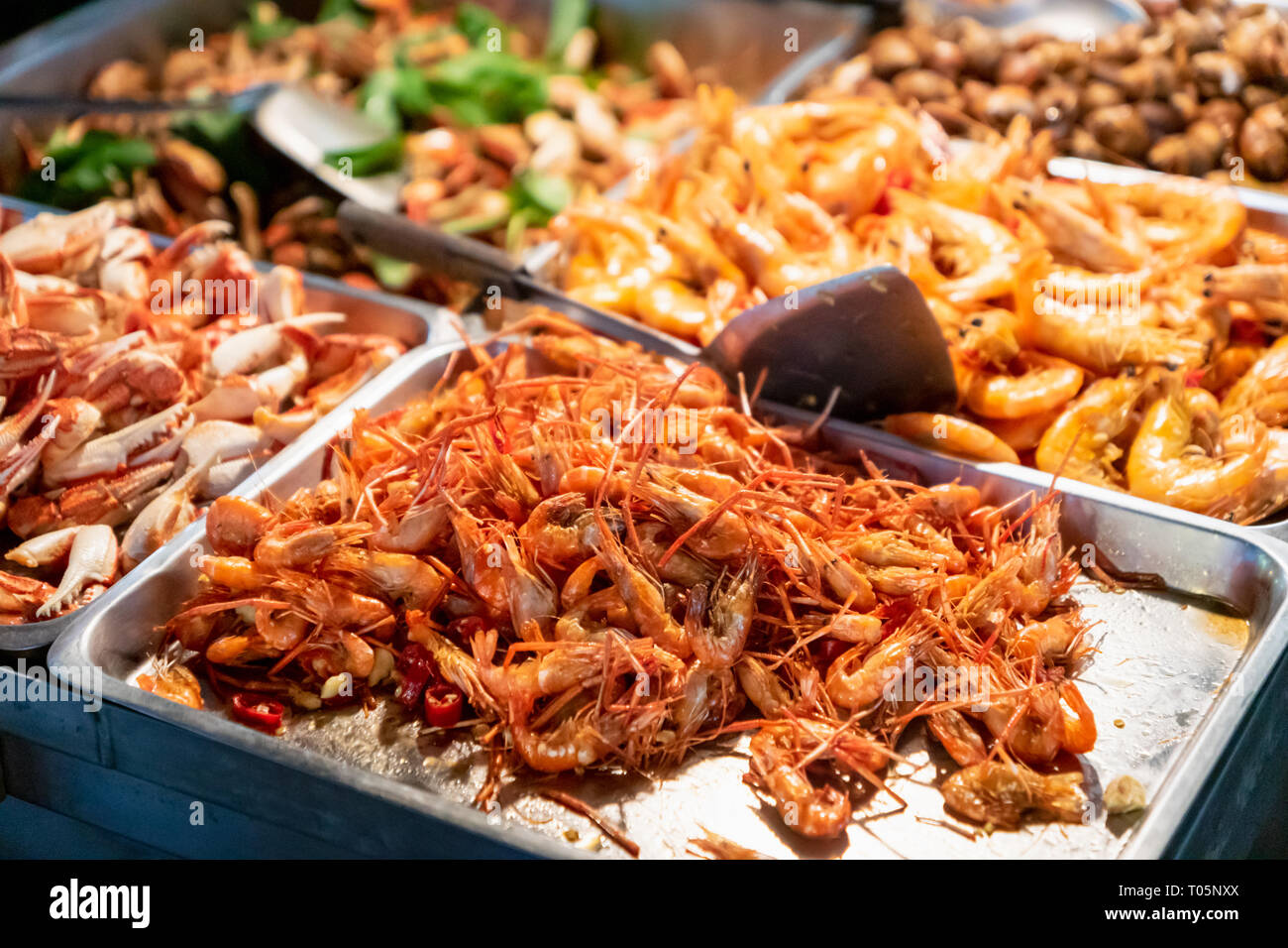 Fried shrimp in street food stall in Asian night market Stock Photo