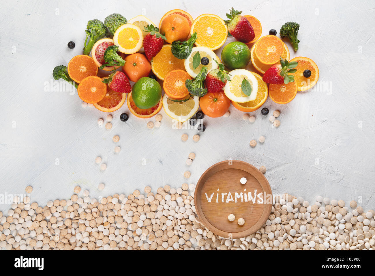 Vitamins in fruits and vegetables and vitamin pills. Top view, flat lay