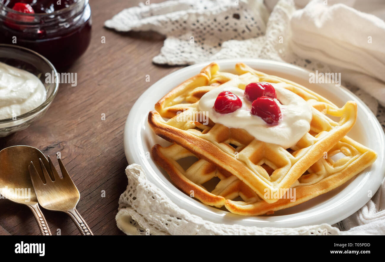 Belgian waffles with sour cream and cherry jam Stock Photo Alamy