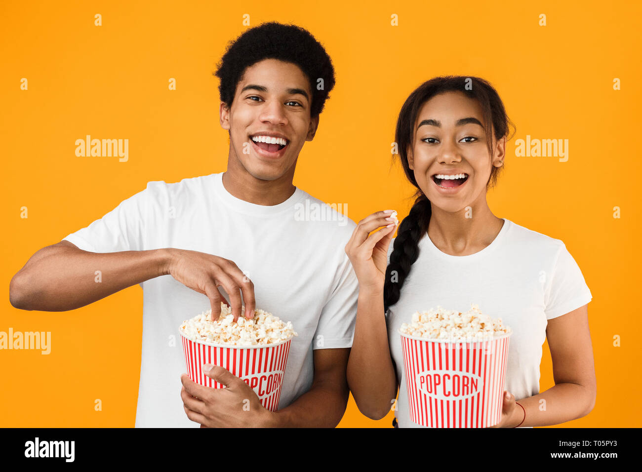 Boy eating popcorn watching movie hires stock photography and images