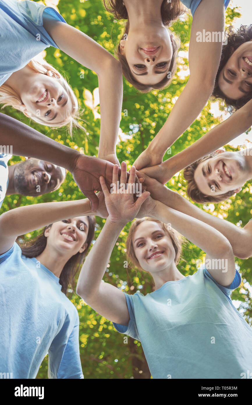 Group of happy volunteers collaborate at park Stock Photo