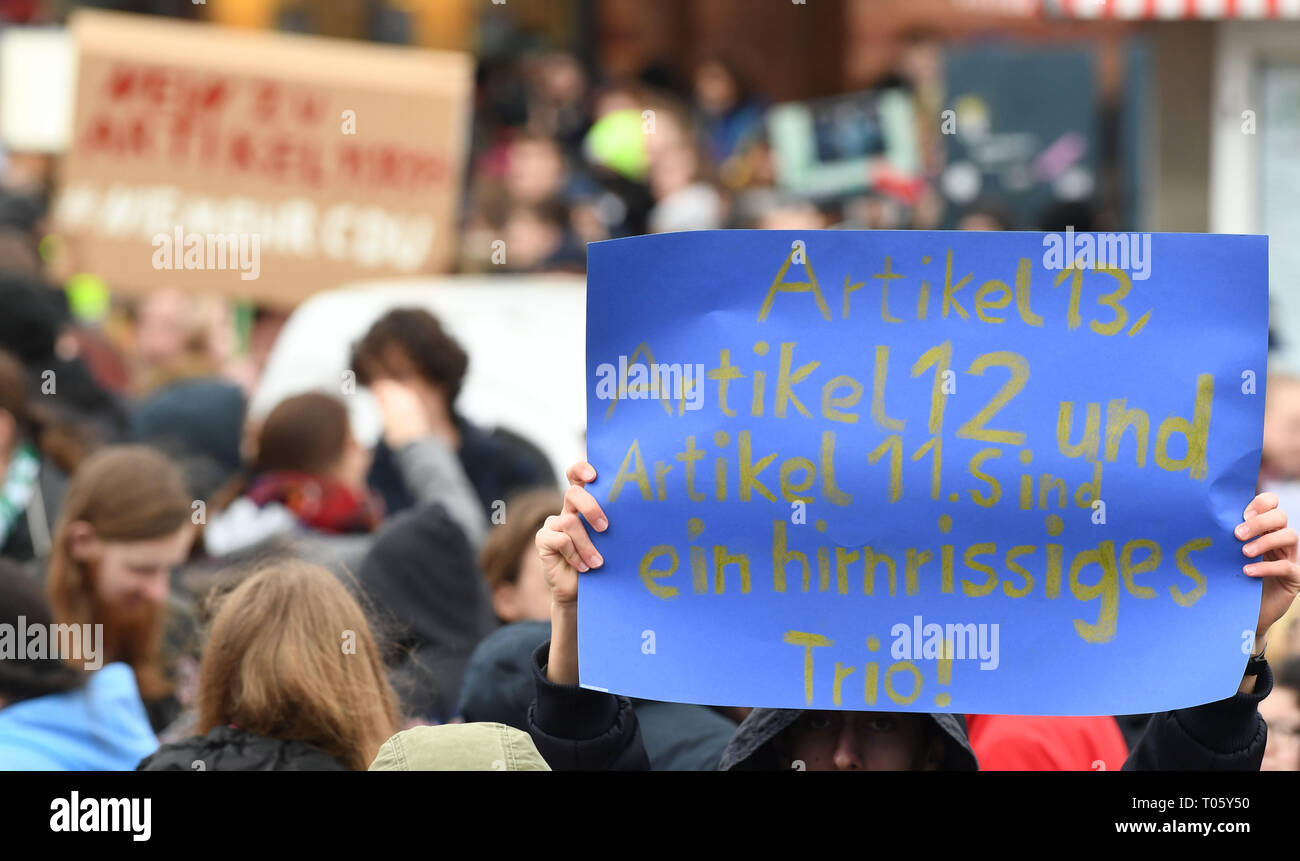 17 March 2019, Bremen: A participant of the demonstration 'Save Your Internet', against upload filter holds up a sign with 'Articles 13, 12 and 11, are a crazy trio! Several hundred people demonstrated at the main railway station against the planned EU copyright reform. Photo: Carmen Jaspersen/dpa Stock Photo