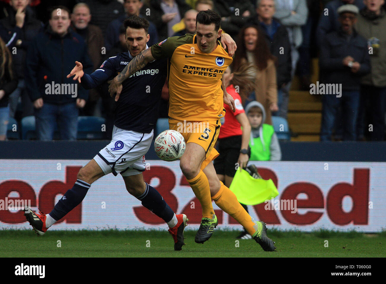 London, UK. 17th Mar, 2019. Lewis Dunk of Brighton & Hove Albion (R) battles with Lee Gregory of Millwall (L). The Emirates FA Cup quarter-final match, Millwall v Brighton & Hove Albion at the Den in London on Sunday 17th March 2019.  this image may only be used for Editorial purposes. Editorial use only, license required for commercial use. No use in betting, games or a single club/league/player publications. pic by Steffan Bowen/Andrew Orchard sports photography/Alamy Live news Credit: Andrew Orchard sports photography/Alamy Live News Stock Photo
