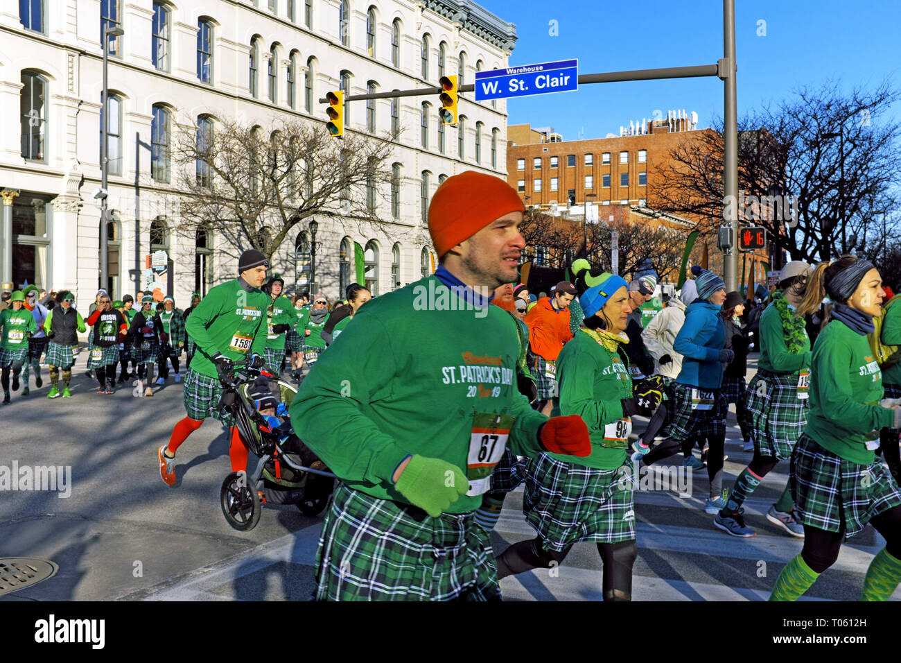 Cleveland, Ohio, USA, 17th March, 2019.  Runners in the 2019 Cleveland St. Patrick's Day Kilt Run attempt to break a world record for the largest kilt run.  Thousands of participants make their way through the Warehouse District stretch of the race.  Credit: Mark Kanning/Alamy Live News. Stock Photo