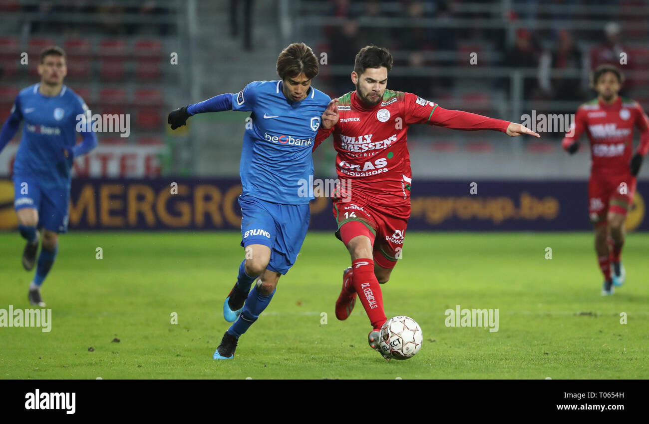 Waregem, Belgium. 17th Mar, 2019. Junya Ito of Genk and Sandy Walsh of  Zulte fight for the ball during the Jupiler Pro League match day 30 between  Zulte Waregem and Krc Genk