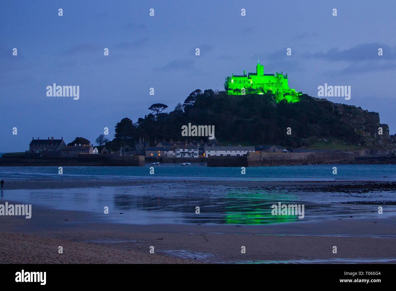 St Michael's Mount, Marazion, UK. 17th March 2019.  The Mount is lit up with green light to celebrate St Patrick's Day. Credit: Mike Newman/Alamy Live News. Stock Photo