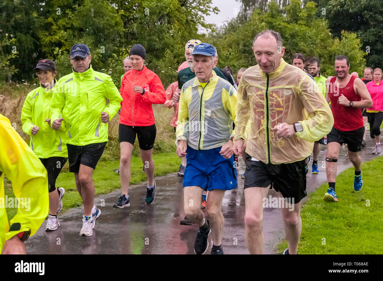 Wet day fun runners Stock Photo Alamy