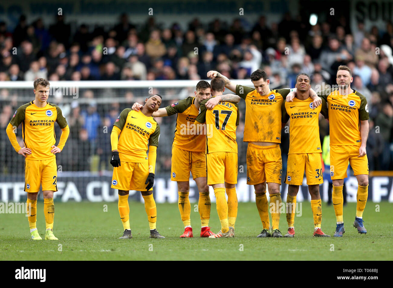 Brighton and Hove Albion players react watching the penalty shoot out during the FA Cup quarter final match at The Den, London. Stock Photo