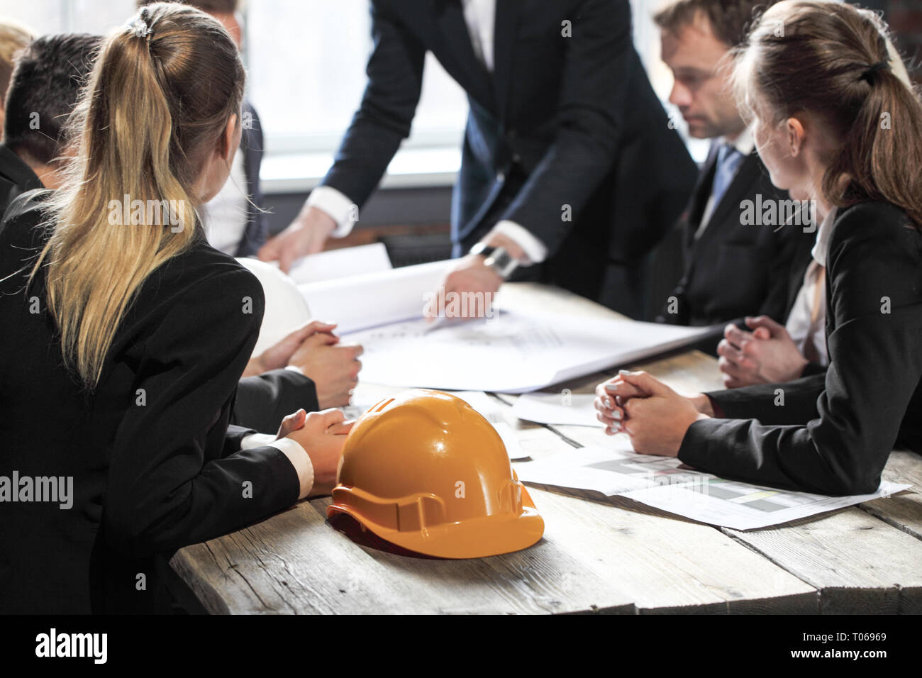 Engineers and businessmen are discussing construction projects in workplace. Construction concept. Stock Photo