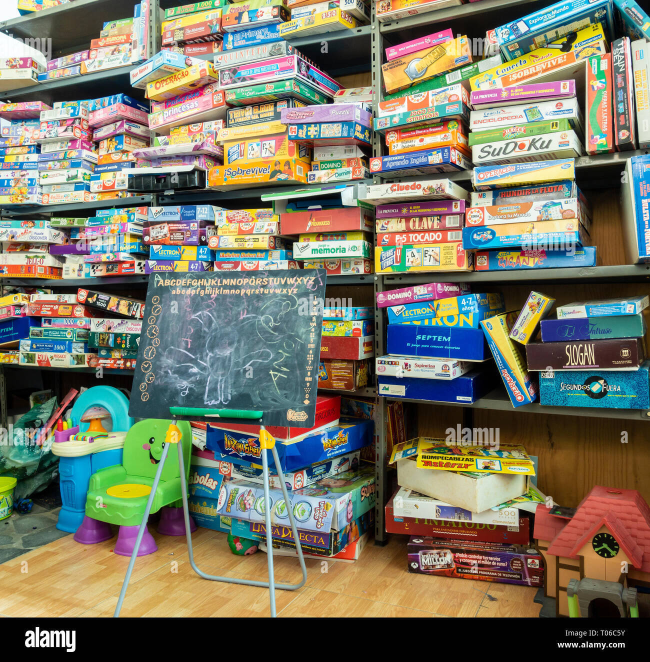 Board games and boxes of toys in charity shop. Stock Photo