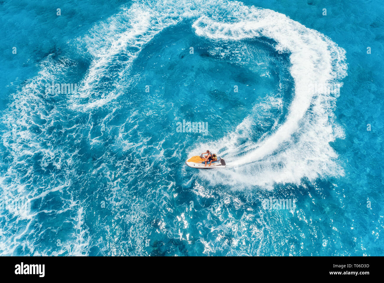 Aerial view of floating water scooter in blue water at sunny day in