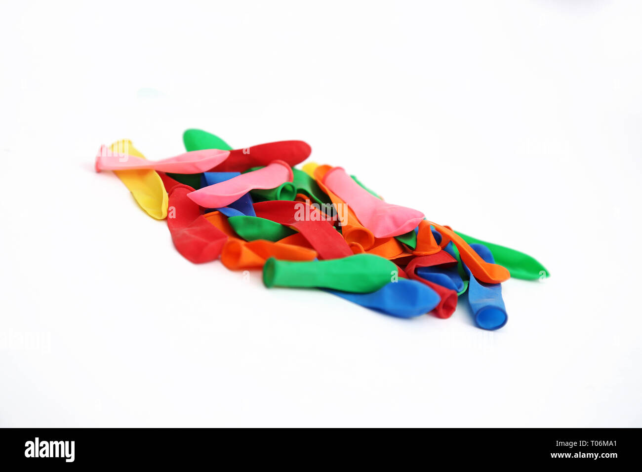 Portrait of colorful deflated water balloons for holi fun. Isolated on the white background