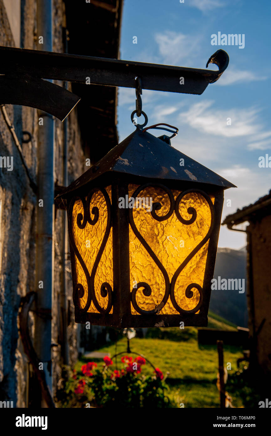 old lantern hanging outside a cottage Stock Photo - Alamy
