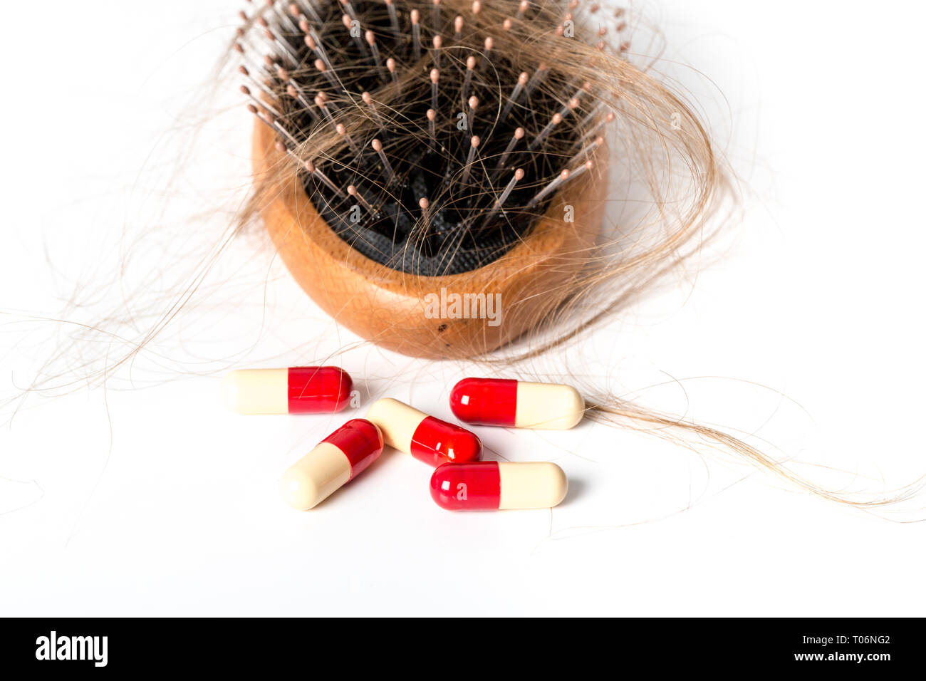 Wood Hairbrush On White Background Close Up With Long Brown Hair