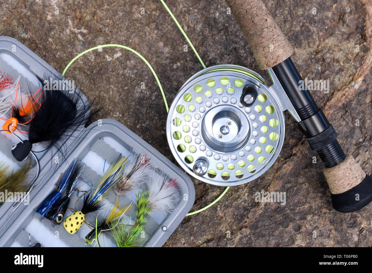 Beautiful Fly Fishing Reel with Flies in a Tackle Box on a Rock Stock Photo  - Alamy