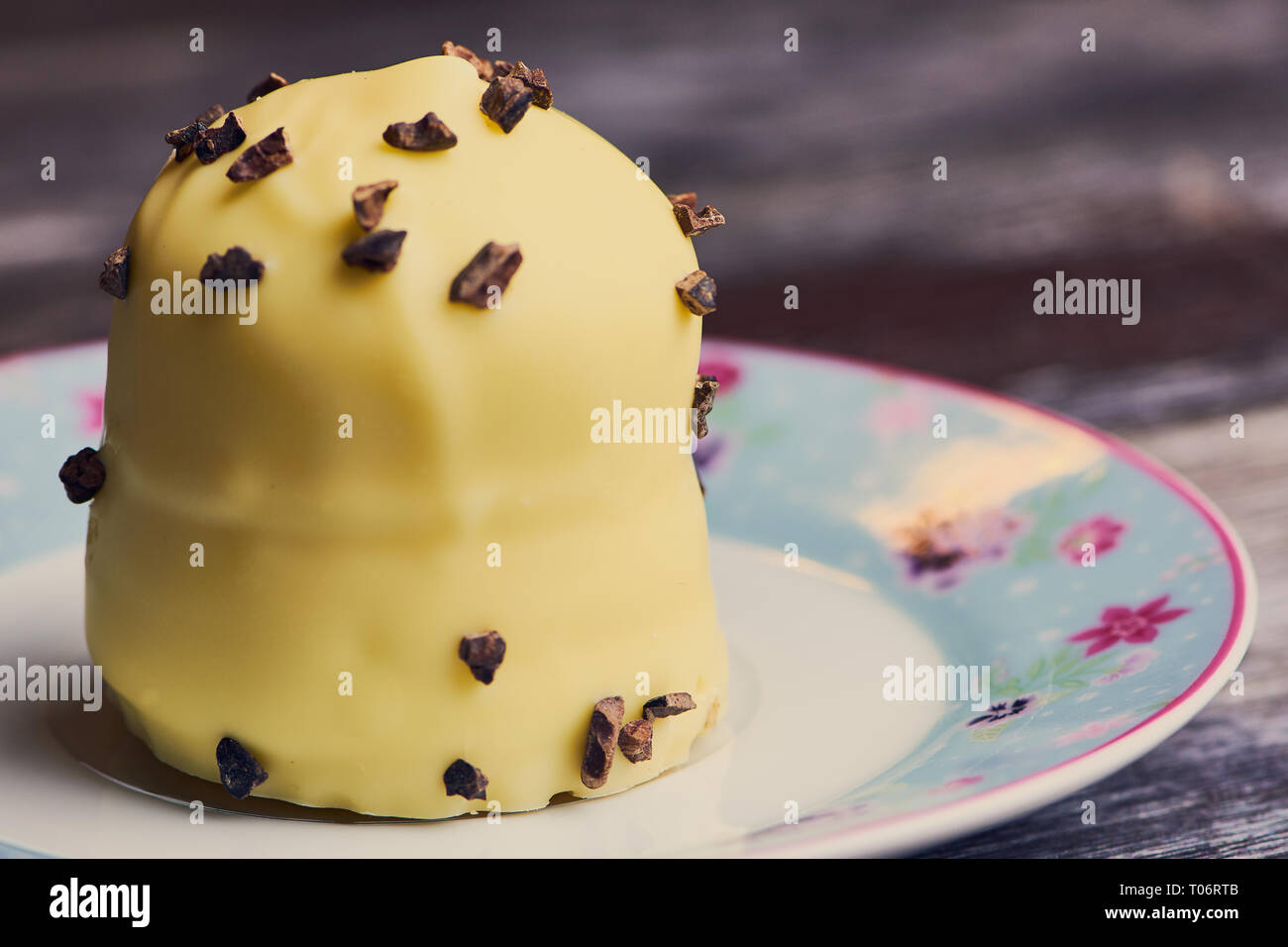 white chocolate covered marshmallow on a small plate on brown wooden surface Stock Photo