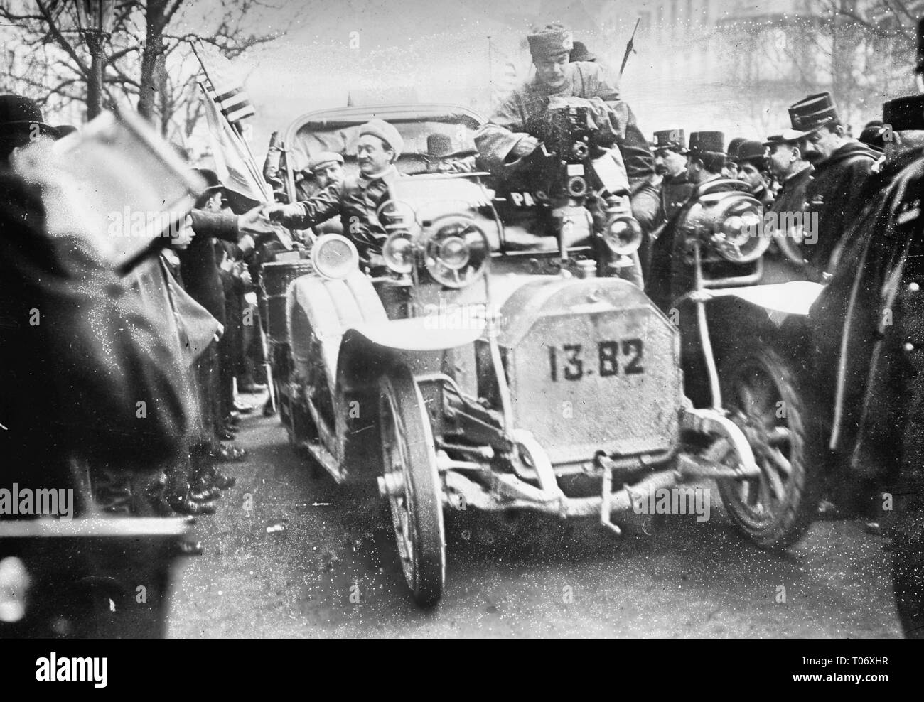 New York - Paris race - Godard in motobloc leaving Paris with moving picture camera, Paris Stock Photo