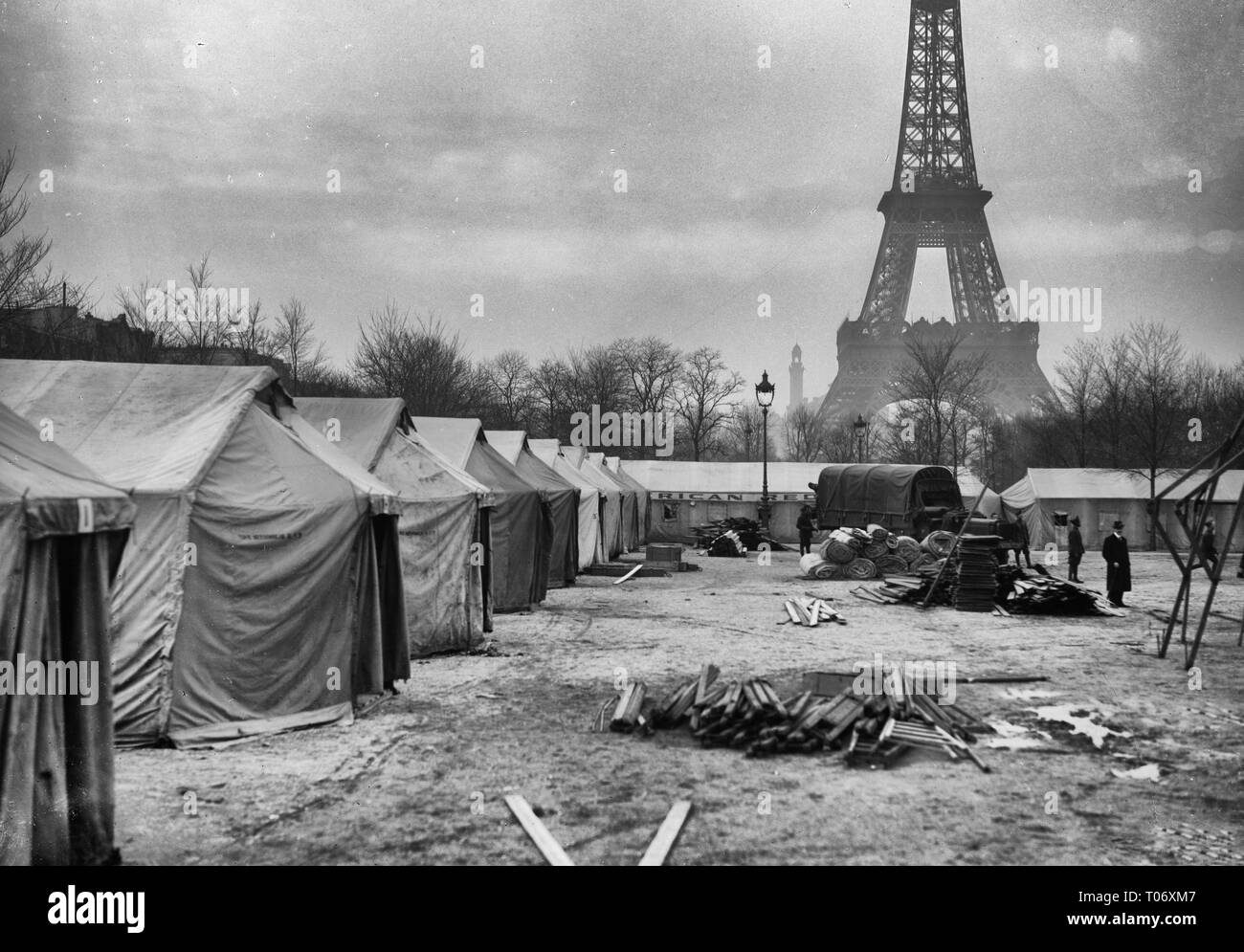 Paris, France. The American Red Cross Enlisted Men's Hotel #13, at Champ de Mars, Paris, in the course of construction. Made entirely out of salvaged tents, there are accomodations for 1,400 men. A fully equipped canteen and recreation hut go to make this hostely complete. The work was started on February, 18th and finished in nine days. It was necessary for the Red Cross to provide sleeping places quickly, for the men, passing through Paris, were coming in great crowds. In the shadow of the Eiffel Tower, it is indeed an ideal site for the purpose. February, 1919 Stock Photo