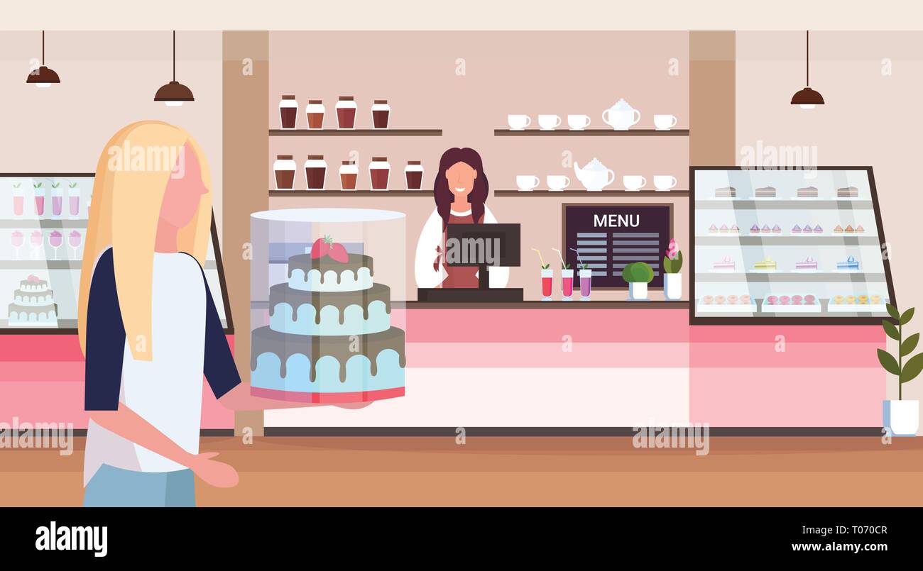 female bakery shop owner standing behind bar counter young woman customer holding cake modern