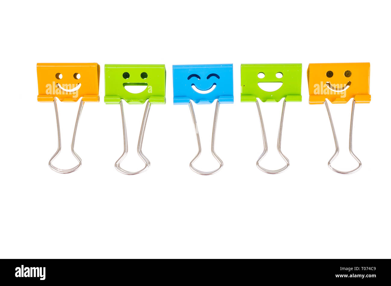 Colored metal paper holders, isolated on white background. Studio Photo