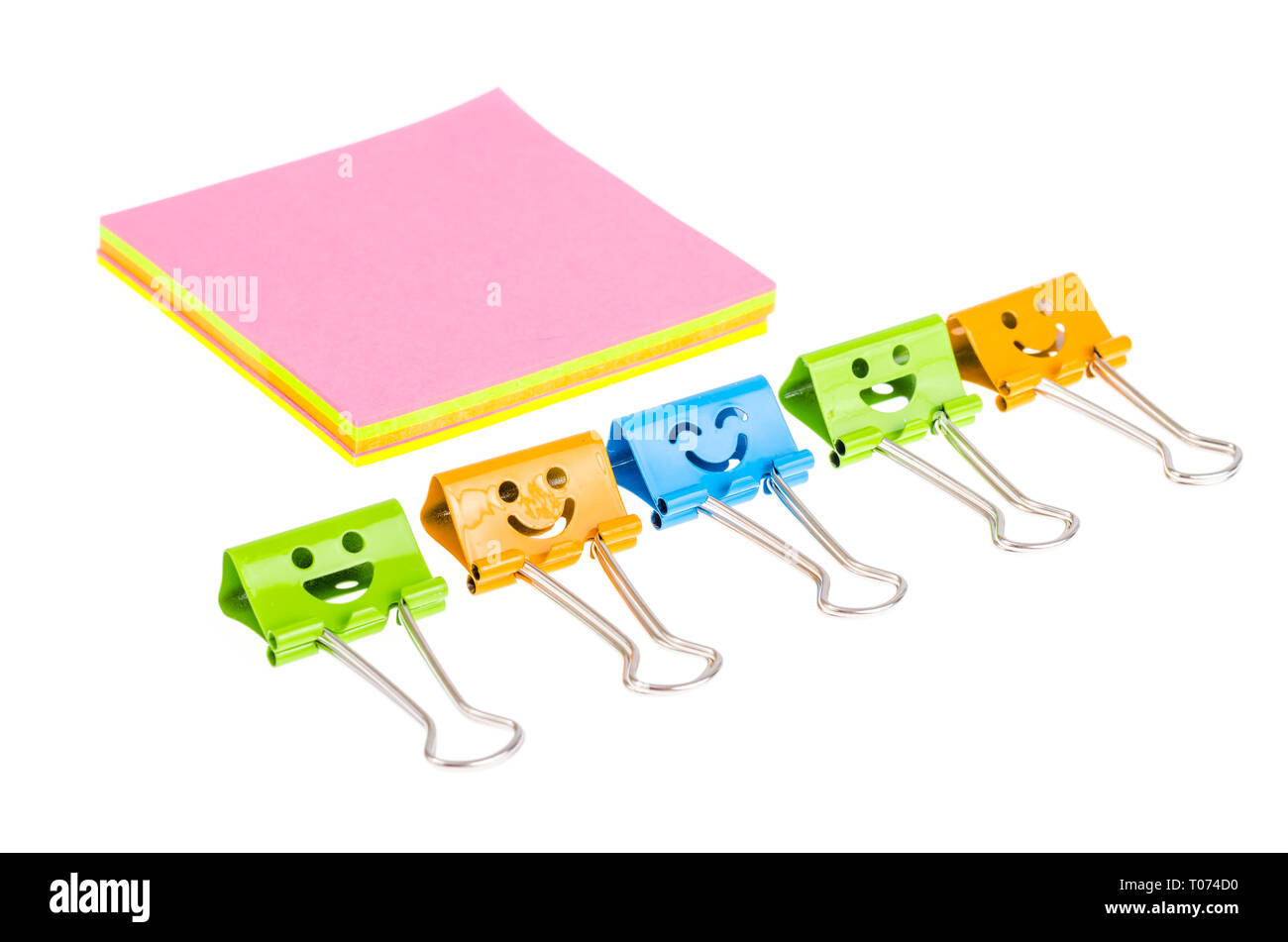 Colored metal paper holders, isolated on white background. Studio Photo