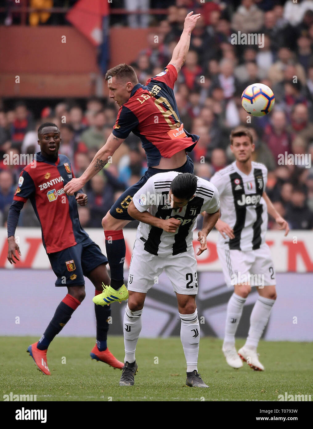 Genoa, Italy. 17th Mar, 2019. Juventus' Emre Can (C bottom) vies with Genoa's Lukas Lerager (C top) during an Italian Serie A match in Genoa, Italy, March 17, 2019. Credit: Alberto Lingria/Xinhua/Alamy Live News Stock Photo