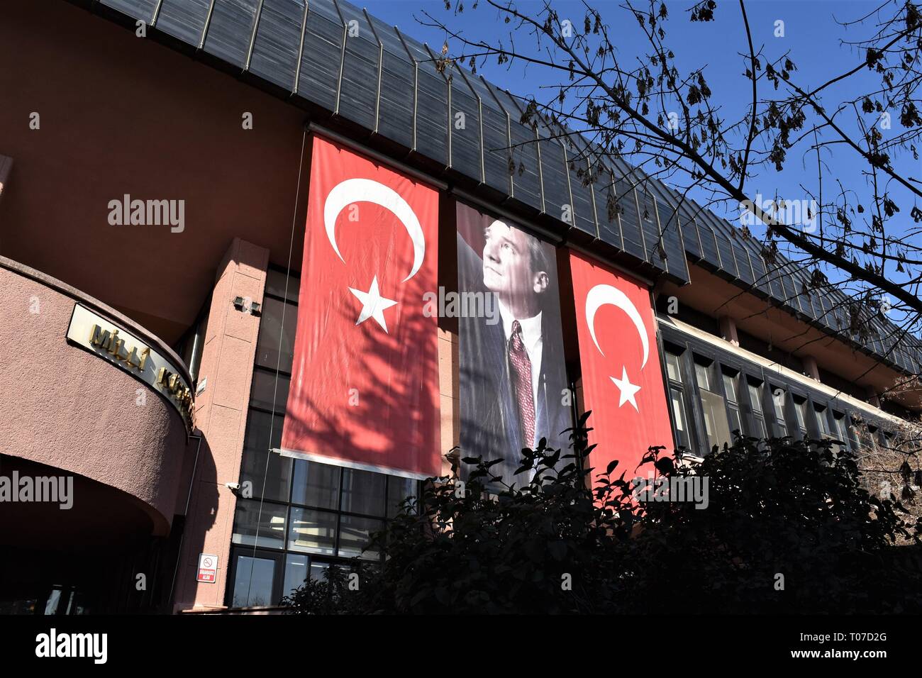 18 March 2019, Turkey, Ankara: A portrait of Mustafa Kemal Ataturk, modern Turkey's founding president, and Turkish national flags are hanged on the National Library building on the occasion of the 104th anniversary of the Canakkale Victory. Photo: Altan Gocher | usage worldwide Stock Photo