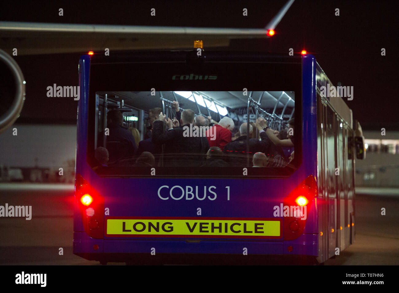 Glasgow, UK. 18 March 2019. The Scotland Football Team seen boarding their luxury jetliner private aircraft in the early hours seen  at Glasgow Airport moments before departing for Kazakhstan to play a game on Wednesday.  The flight was due to take off at 11pm, however due to an unforeseen problem where the pilot had to come out of the flight deck and onto the tarmac and speak with ground crew, the flight eventually took off in the early hours of today. Credit: Colin Fisher/Alamy Live News Stock Photo