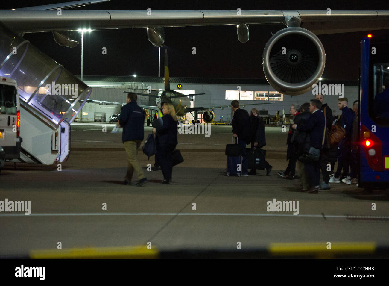Glasgow, UK. 18 March 2019. The Scotland Football Team seen boarding their luxury jetliner private aircraft in the early hours seen  at Glasgow Airport moments before departing for Kazakhstan to play a game on Wednesday.  The flight was due to take off at 11pm, however due to an unforeseen problem where the pilot had to come out of the flight deck and onto the tarmac and speak with ground crew, the flight eventually took off in the early hours of today. Credit: Colin Fisher/Alamy Live News Stock Photo