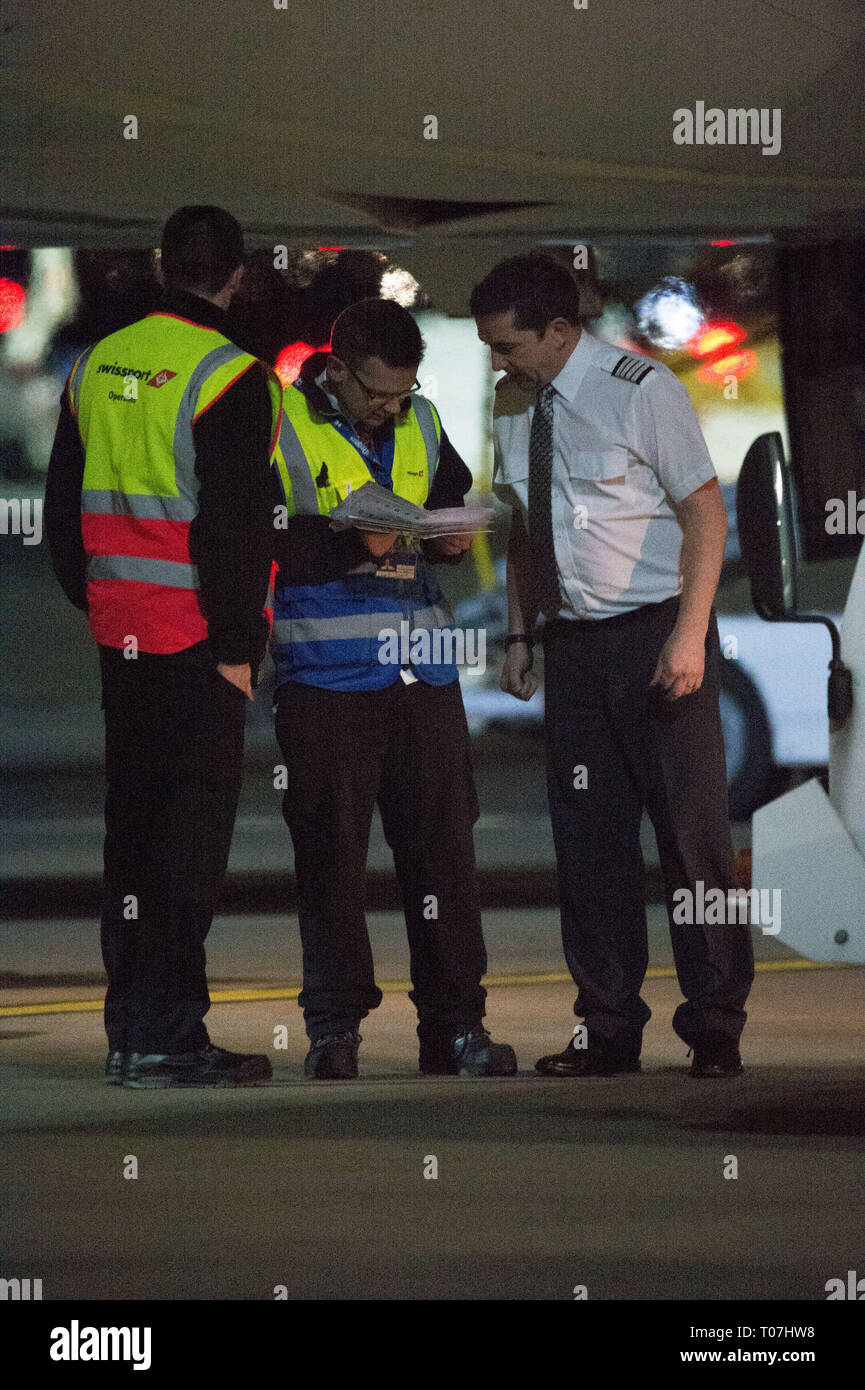 Glasgow, UK. 18 March 2019. The Scotland Football Team seen boarding their luxury jetliner private aircraft in the early hours seen  at Glasgow Airport moments before departing for Kazakhstan to play a game on Wednesday.  The flight was due to take off at 11pm, however due to an unforeseen problem where the pilot had to come out of the flight deck and onto the tarmac and speak with ground crew, the flight eventually took off in the early hours of today. Credit: Colin Fisher/Alamy Live News Stock Photo