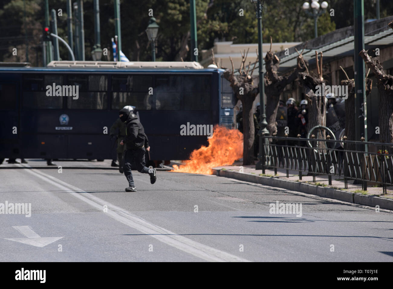 A protester from the black block hurls a petrol bomb at riot police. A few thousands high school students took to the streets to demonstrate against upcoming reforms in education, which they claim will drive them to seek for paid supplementary education putting an additional financial burden to their parents.© Nikolas Georgiou / Alamy Live News Stock Photo