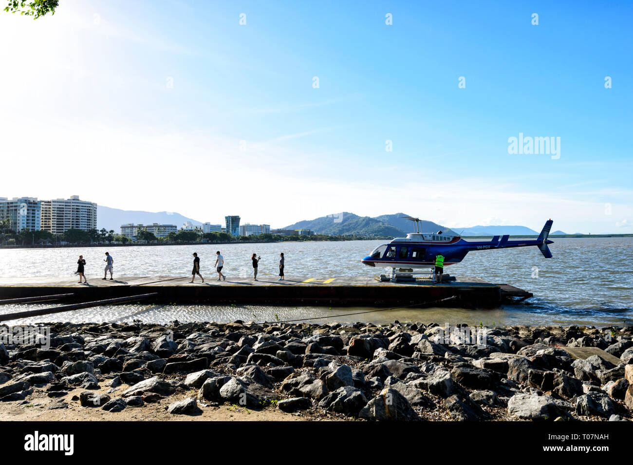 Tourists getting out of a helicopter scenic flight, Cairns, Far North Queensland, FNQ, QLD, Australia Stock Photo