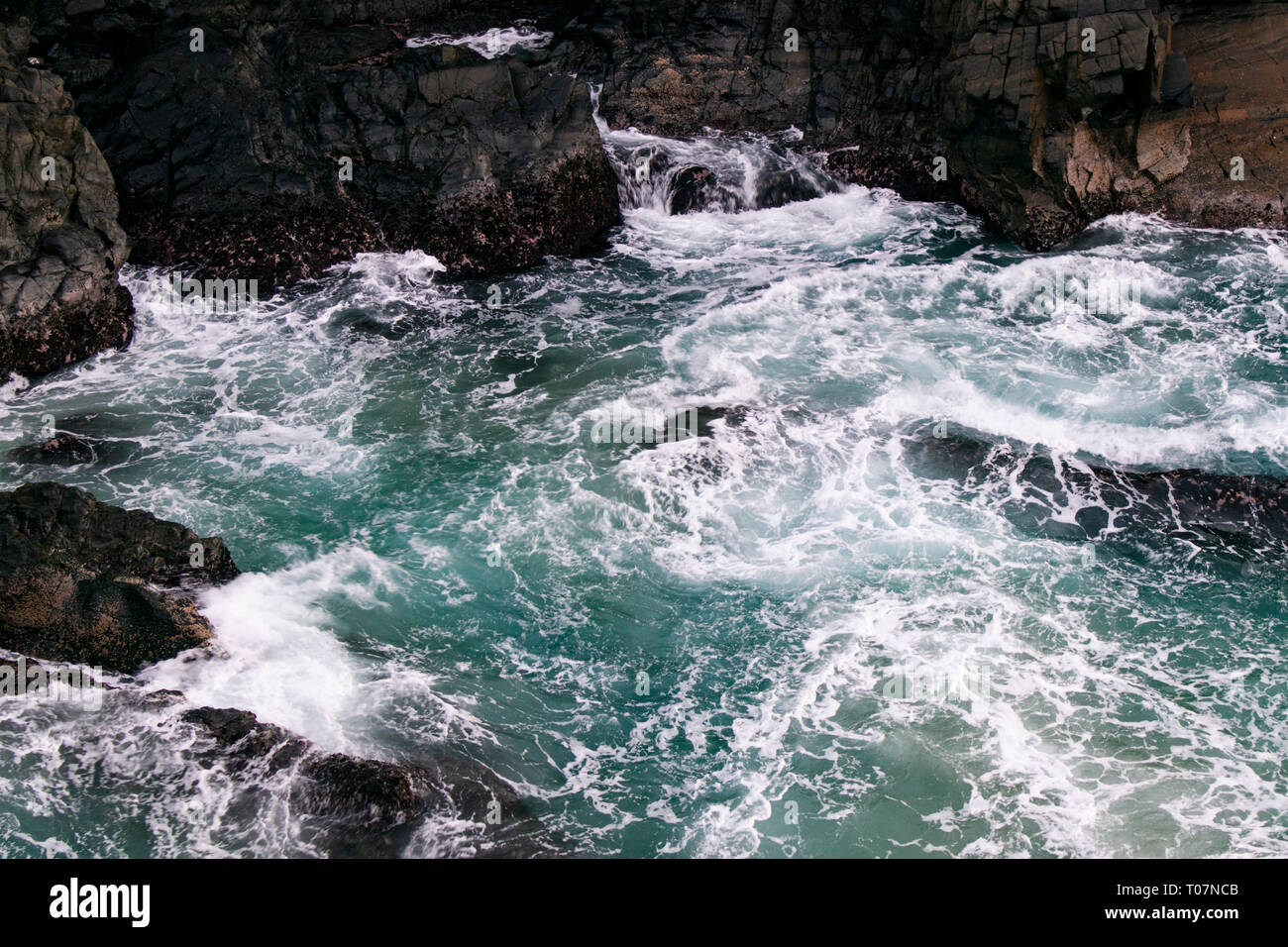 Waves crashing on rocks Stock Photo