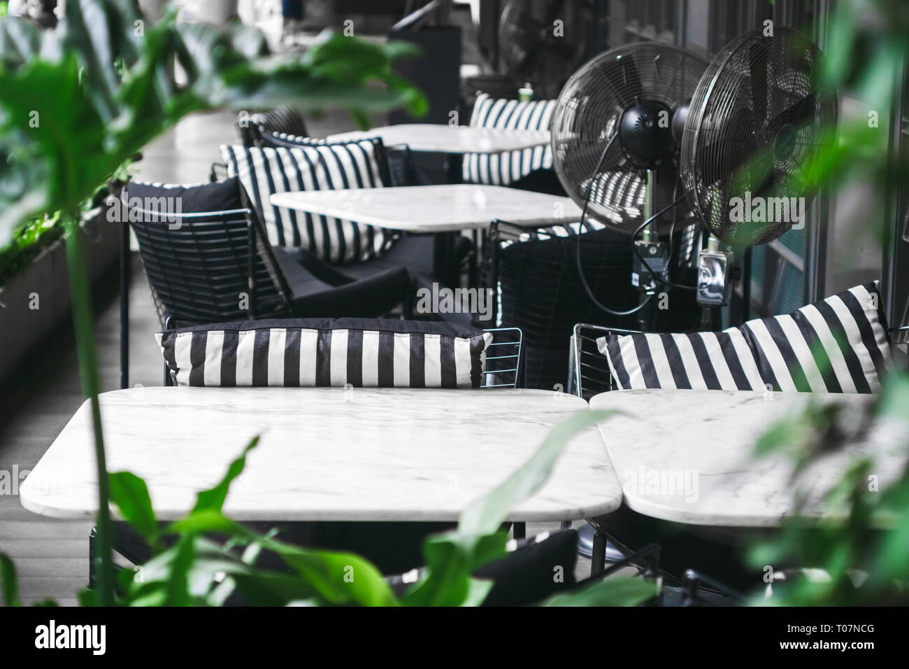 A outdoor marble tables and chairs with cozy black and white