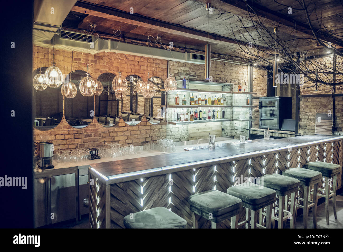 Photo of loft bar brick interior being decorated with lighting Stock ...