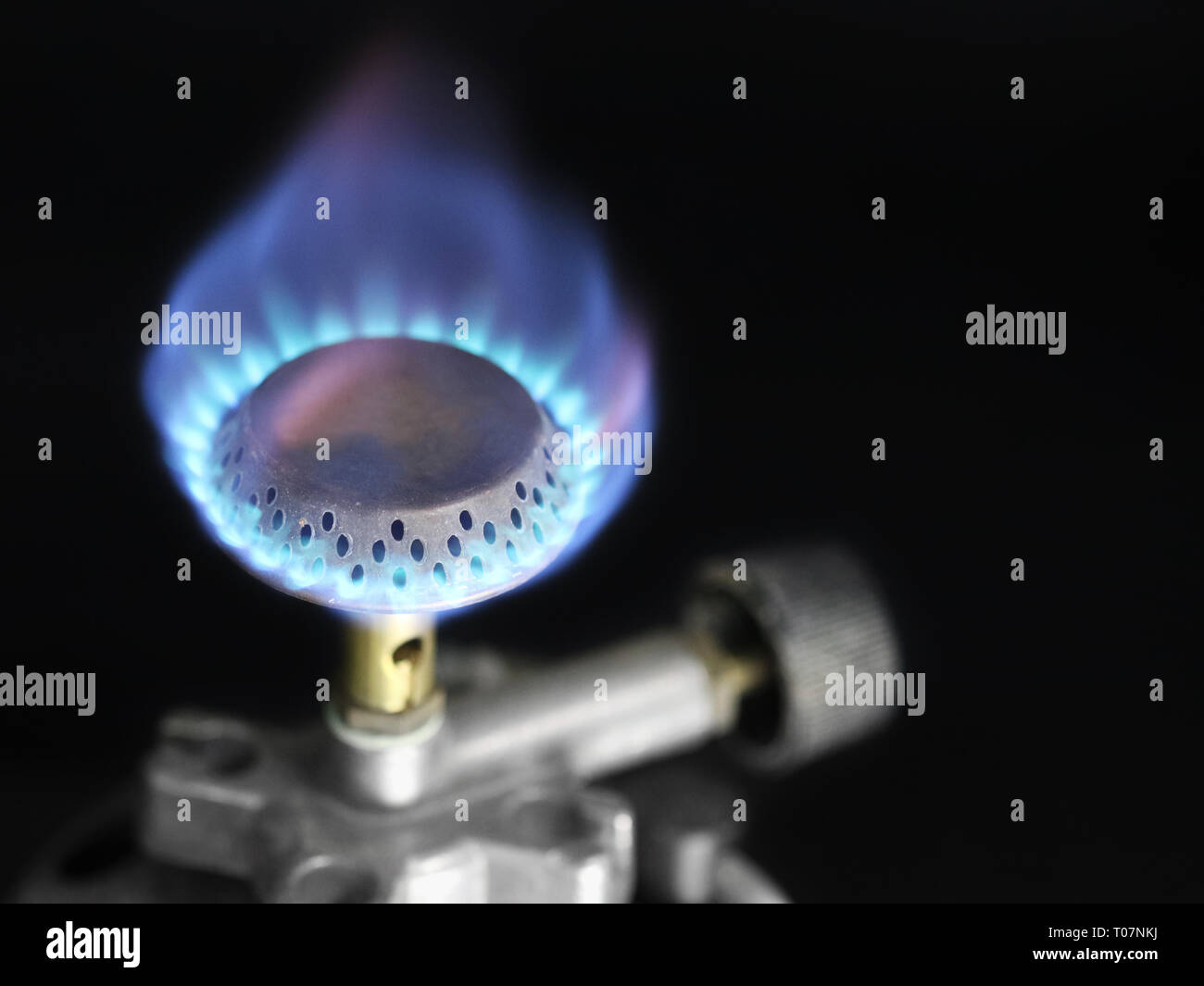 Flame of a gas burner, cartridge burner on black background with copy space Stock Photo