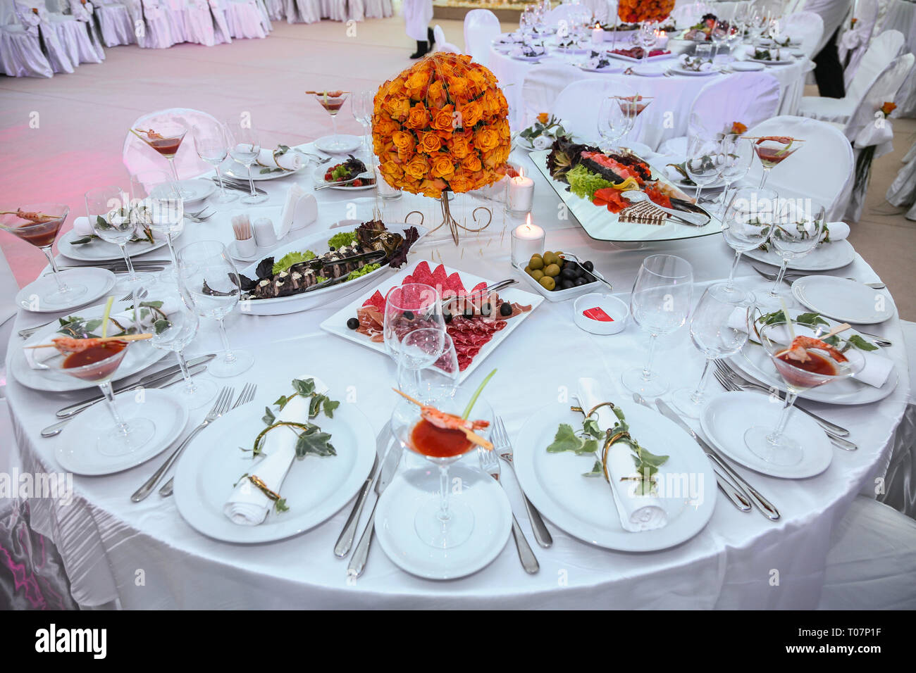 Holiday table setting decorated with flowers and candles Stock Photo ...