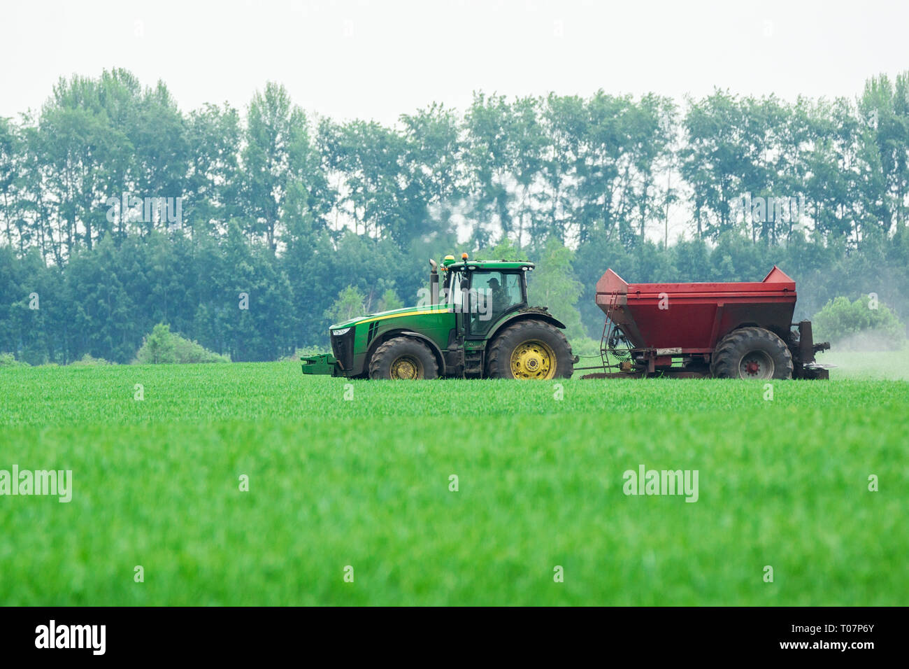 Tractor in field mows grass hi-res stock photography and images - Alamy