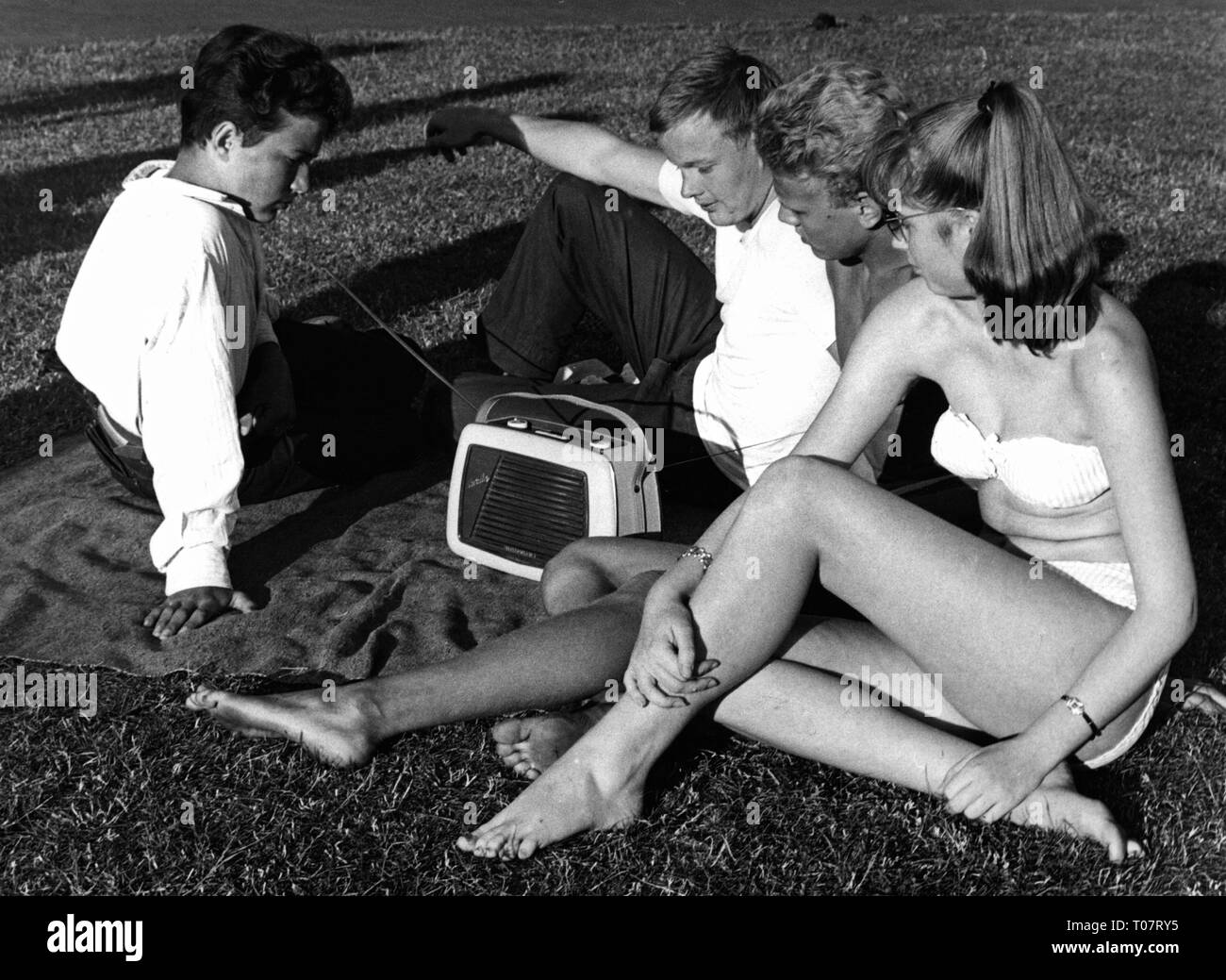 people, teenager, a group of teenagers on a meadow are listening to the radio, Germany, late 1950s, , Additional-Rights-Clearance-Info-Not-Available Stock Photo