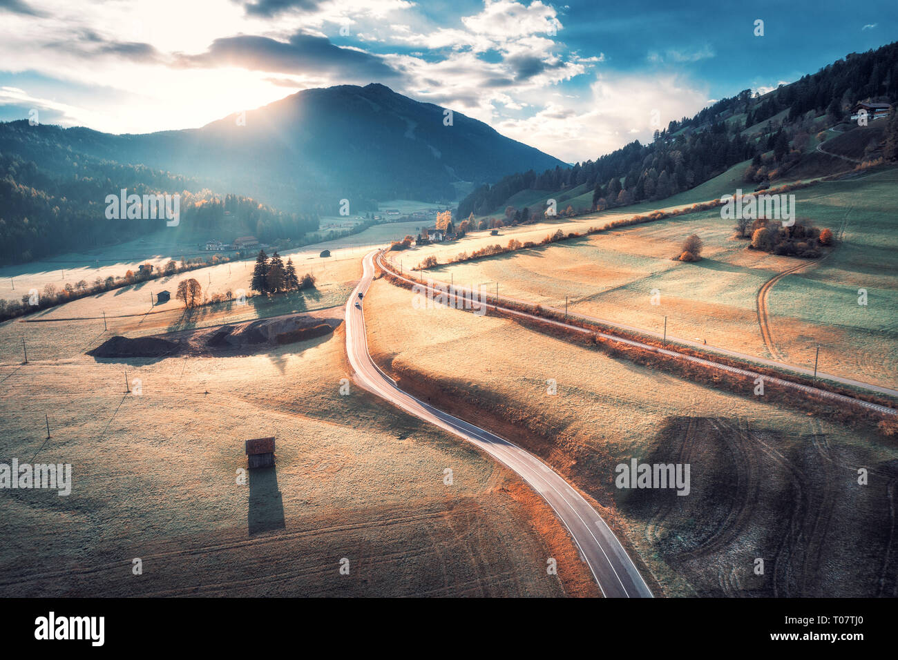 Aerial view of the road in mountain valley at sunset in Dolomites ...