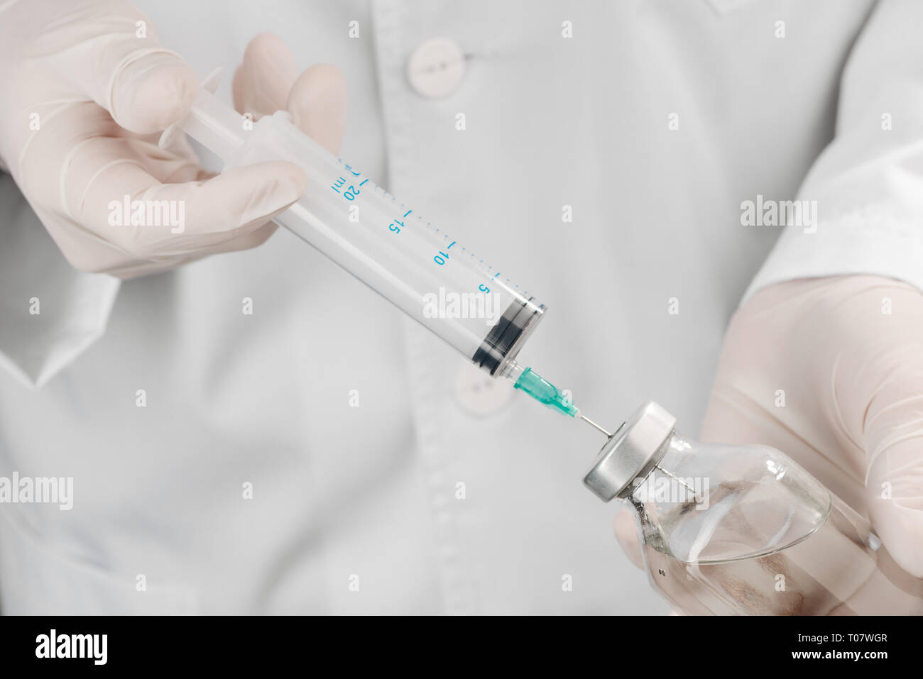 Filling a syringe with saline Stock Photo Alamy