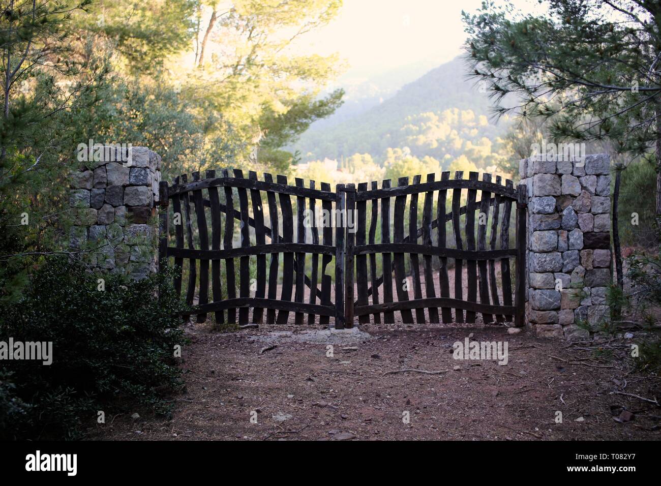 Beautiful traditional Spanish wooden gates in the Mallorca countryside at sunset Stock Photo