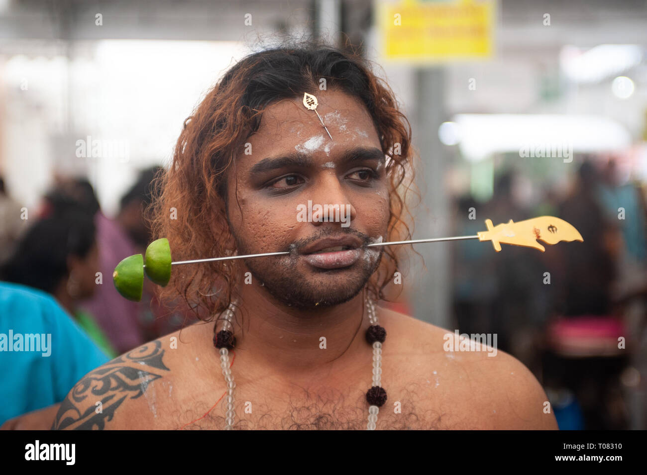 21.01.2019, Singapore, Singapore, Singapore - The jaws of a believing Hindus are pierced with a metal skewer as he prepares for the procession at the  Stock Photo