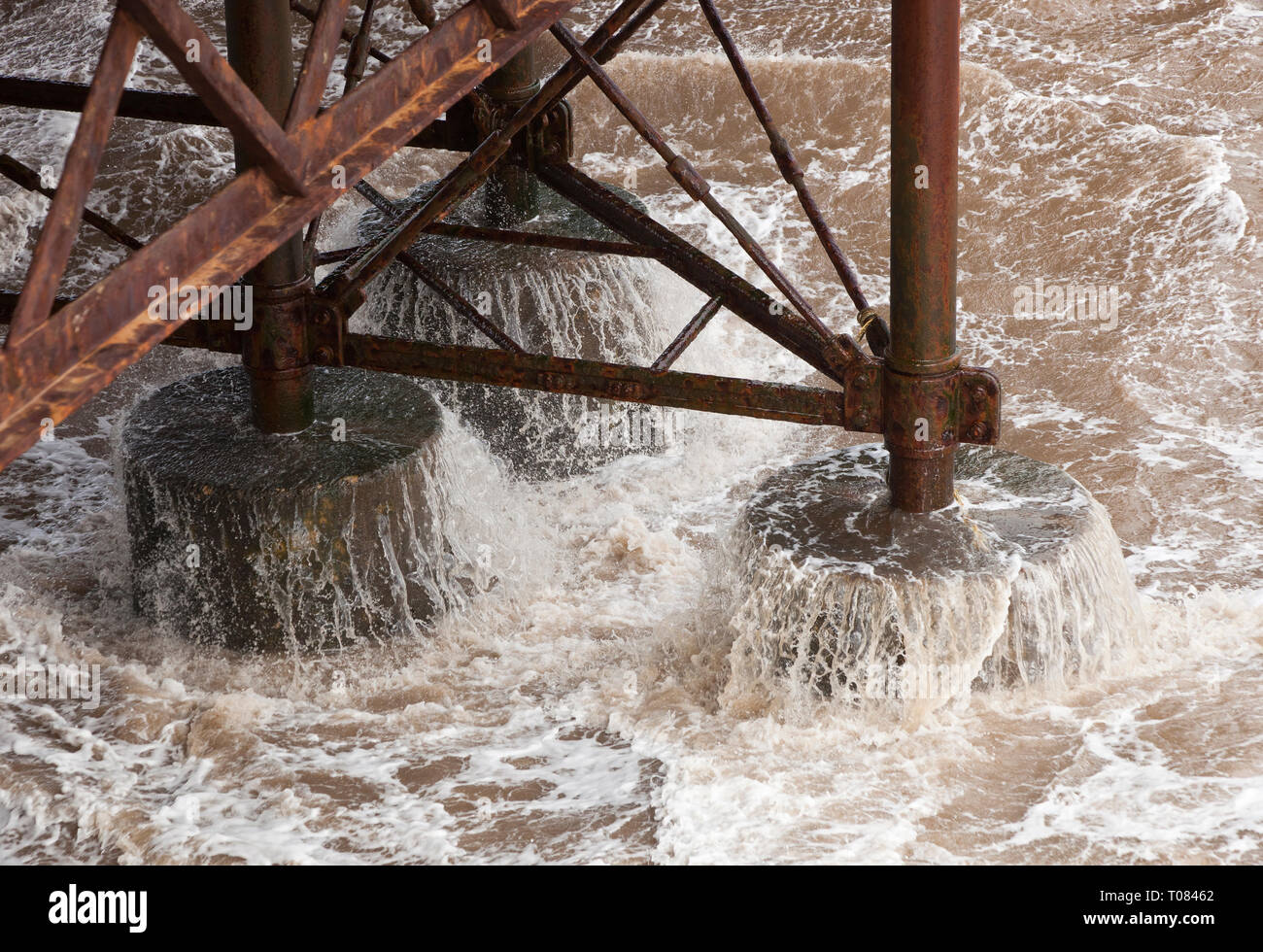 Water draining from the pillars under the pier at Cromer in Winter in