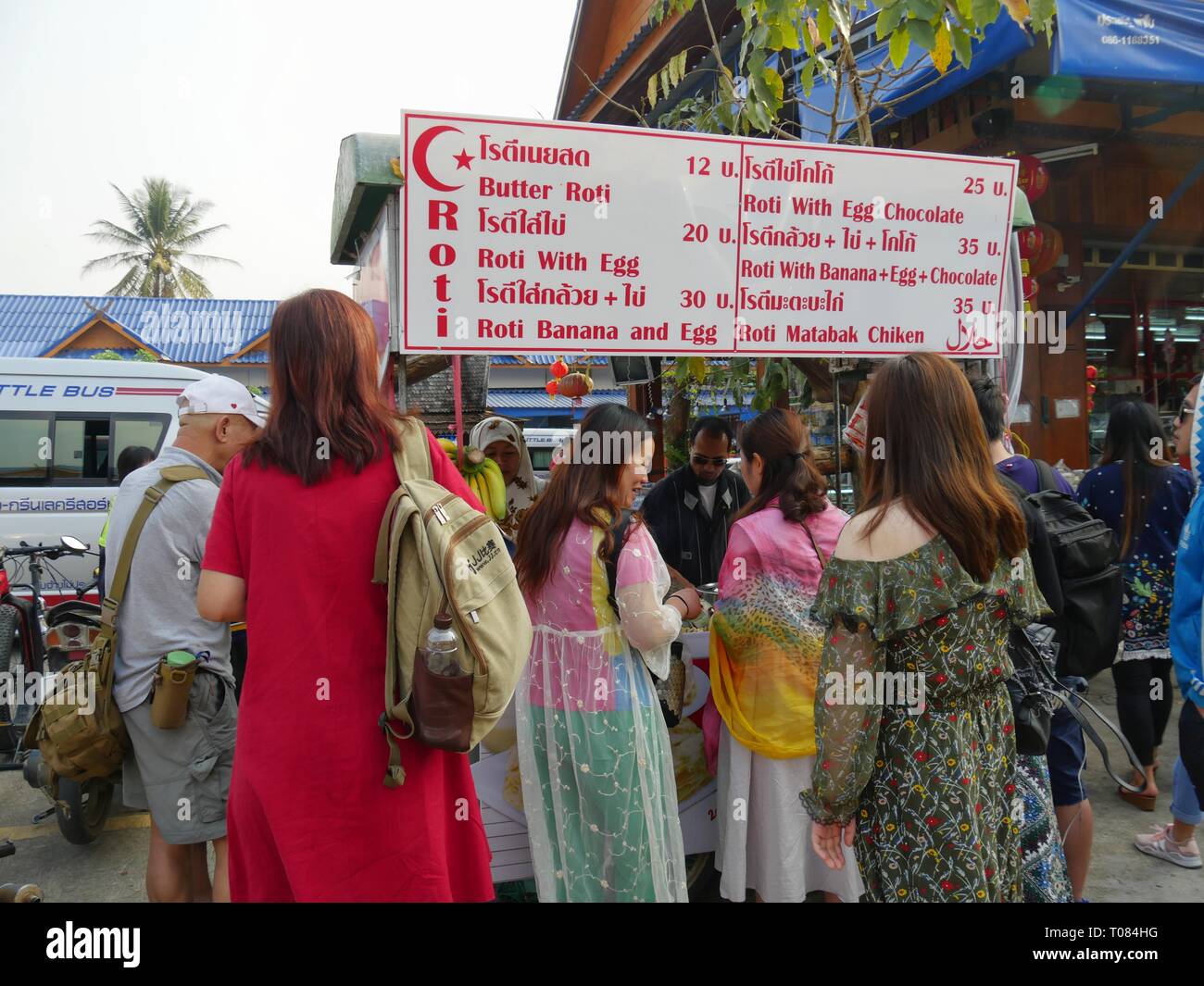 Steling Roti CHIANG MAI, THAILAND—MARCH 2018: Tourists crowd around a stall selling ...