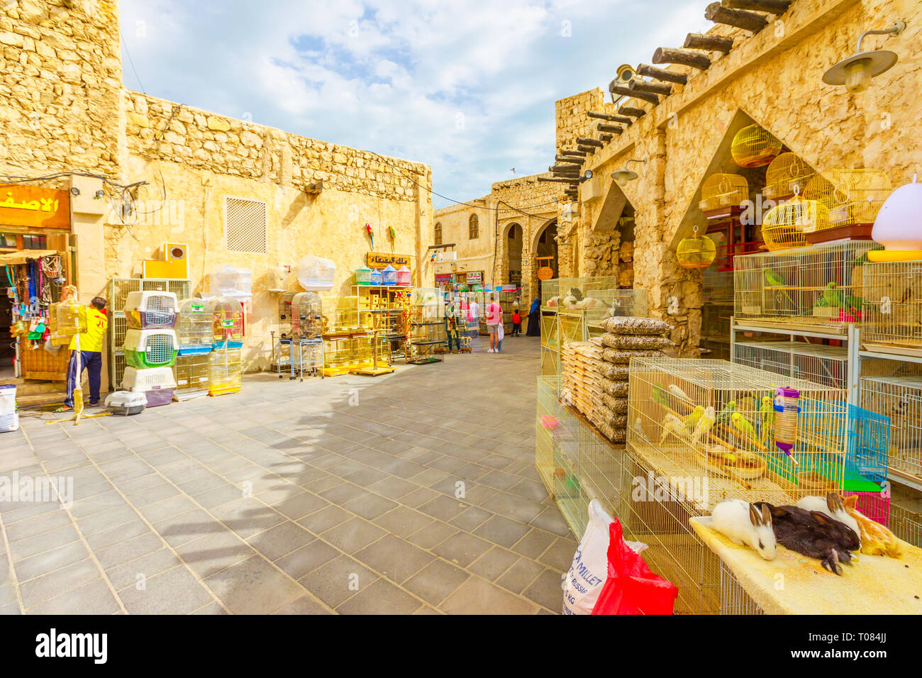 Doha, Qatar - February 19, 2019: rabbits, parrots, pet shop and cages at Bird Souq inside Souq Waqif, the animal market and popular tourist attraction Stock Photo