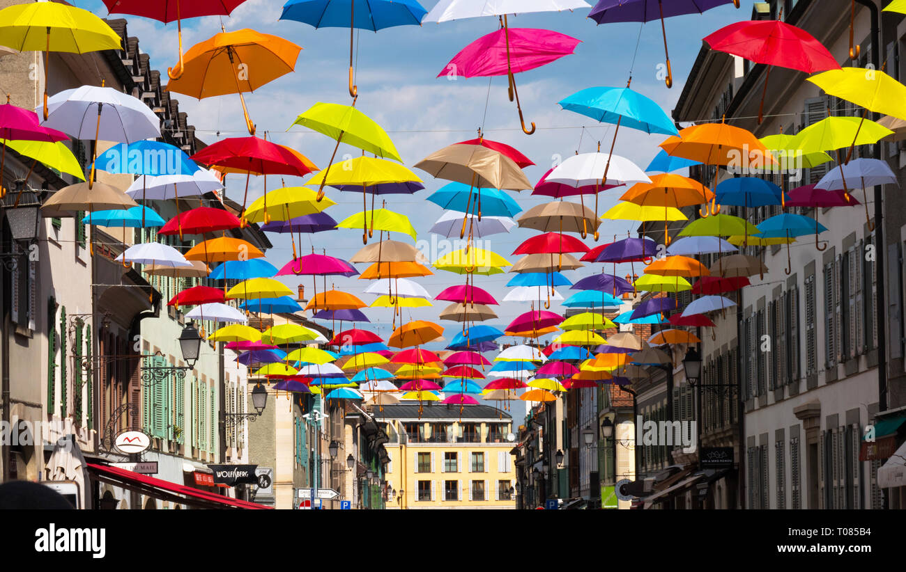 A modern brightly colored street art installation in the town of Geneva,  Switzerland. Brightly colored umbrellas hang above a modern urban street  Stock Photo - Alamy
